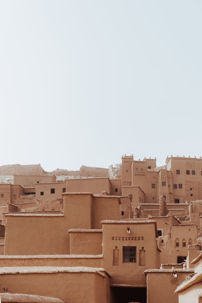 Explore the historic traditional mud-brick architecture of Ait Ben Haddou Kasbah under a clear sky.